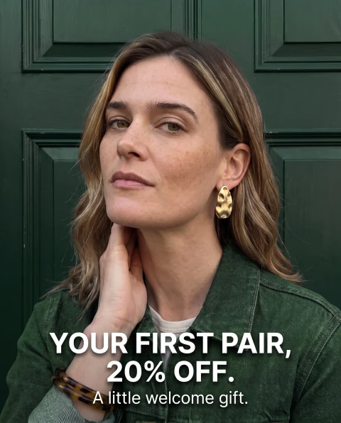Gold earrings portrait. “YOUR FIRST PAIR, 20% OFF. A little welcome gift.”